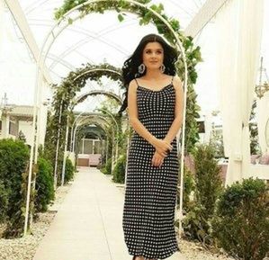 Portrait of a smiling woman standing against plants