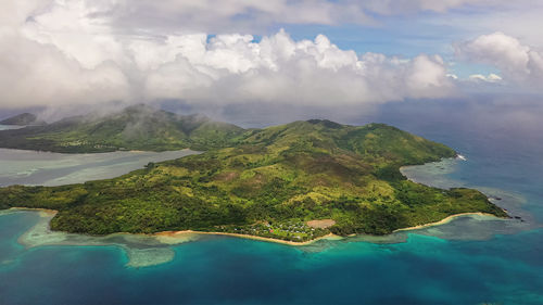 Scenic view of sea and mountains against sky