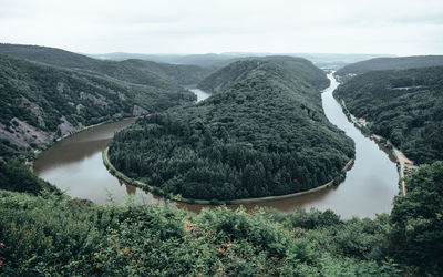 Scenic view of river amidst mountains against sky