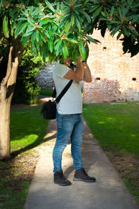 Rear view of man standing on footpath