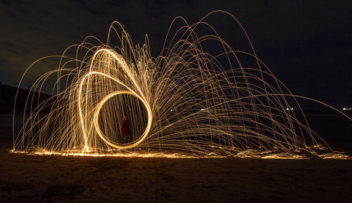 Wire wool against sky at night