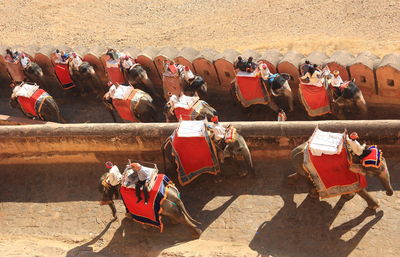 High angle view of people riding elephant at fort