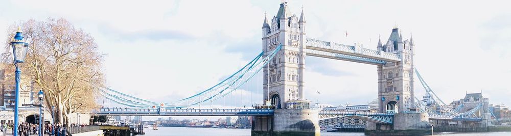 View of bridge and cityscape against sky