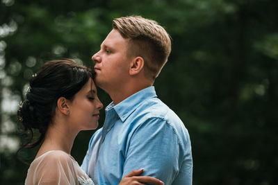 Portrait of couple kissing outdoors