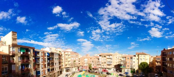 Buildings against cloudy sky