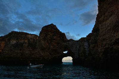 Scenic view of rock formation in sea against sky