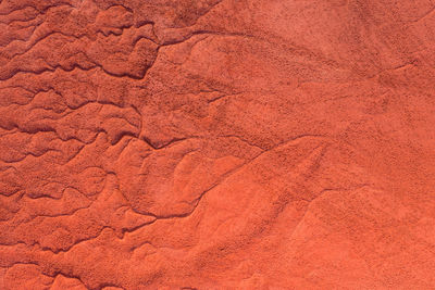 Aerial view of drought red mud surface, industry waste, abstract texture.