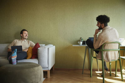 Homosexual couple relaxing in living room