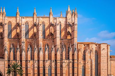 Low angle view of old cathedral against blue sky