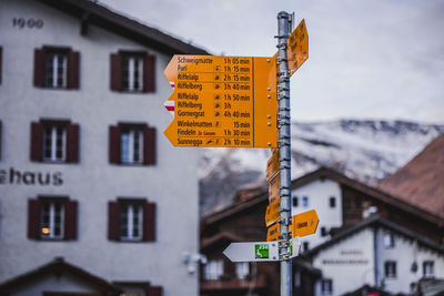 Close-up of road sign against building
