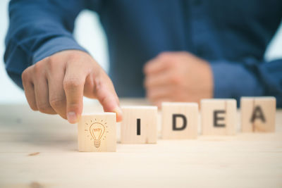 Midsection of man holding text on table