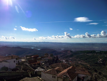 High angle view of townscape by sea against sky