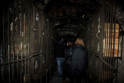 Rear view of people walking in corridor