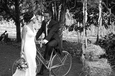 People sitting on bicycle against trees