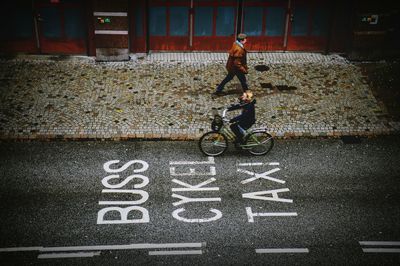 High angle view of woman riding bicycle on street