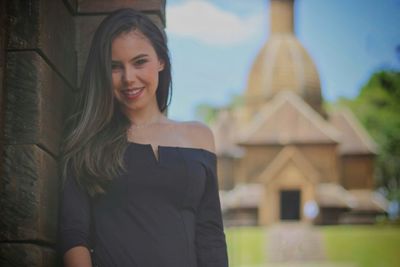 Portrait of a smiling young beautiful woman at the park