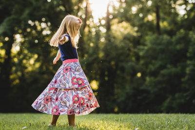 Rear view of person standing on grass