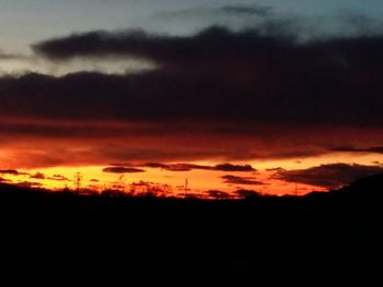 Silhouette of landscape against cloudy sky