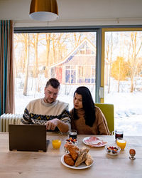 Couple sitting by on table