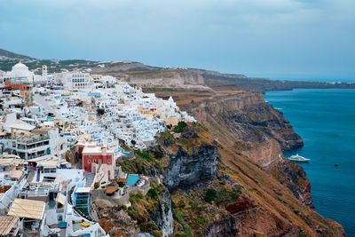 High angle view of townscape by sea against sky