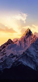 Scenic view of snowcapped mountains against sky during sunset