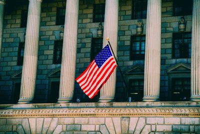 Low angle view of flag against building