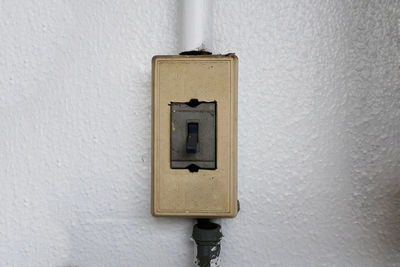 Close-up of electric lamp on wall