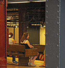 Woman sitting on bench at table