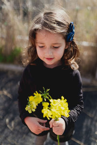 Close-up of girl with pink flower