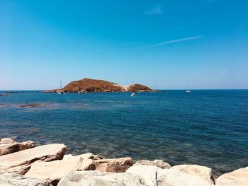 Scenic view of sea against blue sky