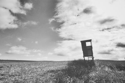 Lifeguard hut on field against sky