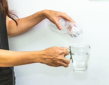Midsection of woman holding ice cream in glass