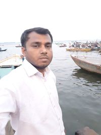 Portrait of young man standing in sea