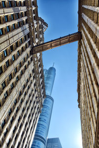 Low angle view of skyscrapers against clear blue sky