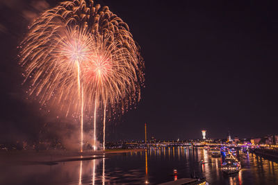 Low angle view of firework display at night