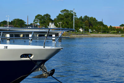 Boat moored on sea against clear sky