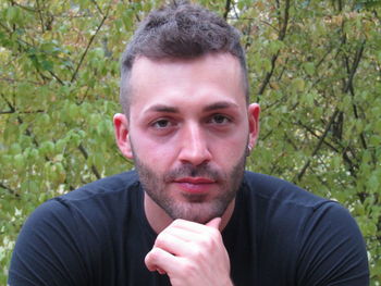 Portrait of young man against plants