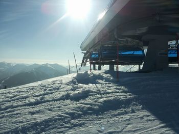 Ski lift over snow covered mountain