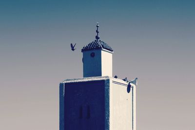 Low angle view of lighthouse against blue sky