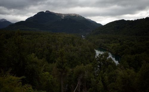 Scenic view of green landscape and mountains against sky