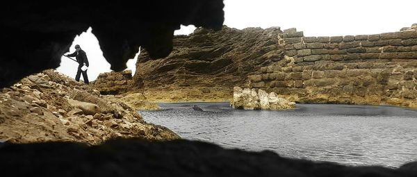 Rock formations by sea against sky