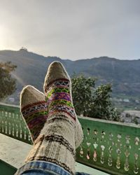 Relaxing under the winter sun, hand knitted colour full socks, kullu socks