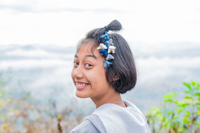 Portrait of smiling young woman in water