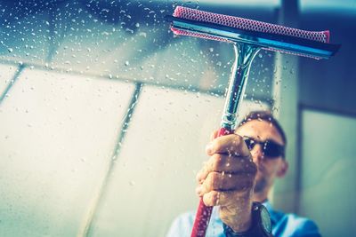 Man cleaning window glass