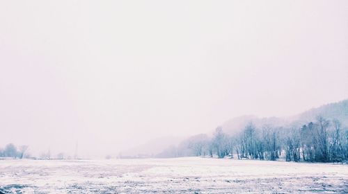 Scenic view of landscape against sky during winter