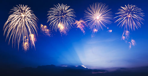 Low angle view of firework display at night