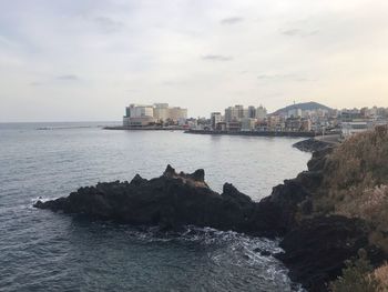 Scenic view of sea and buildings against sky