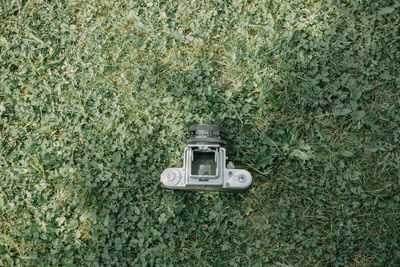 High angle view of an analog camera on field
