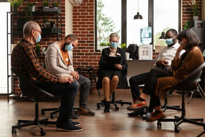 Low section of people sitting on street