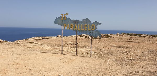 Lifeguard hut on beach against clear sky